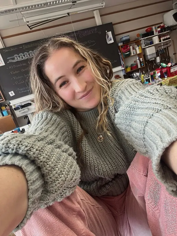 Evelyne smiling in her classroom