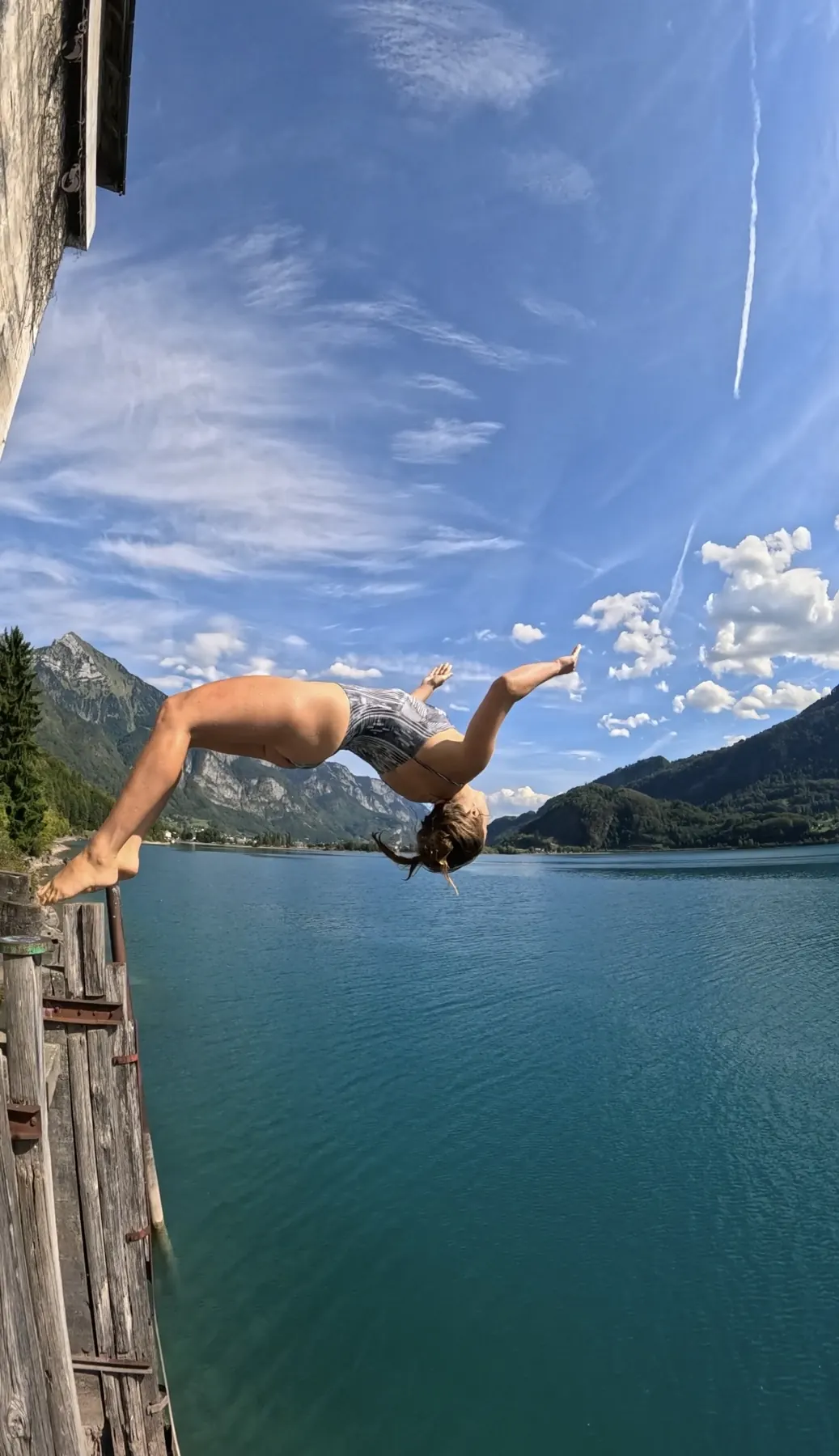 Backflip into a turquoise mountain lake