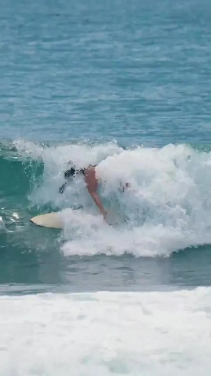Evelyne surfing a wave, still from her 90-second film